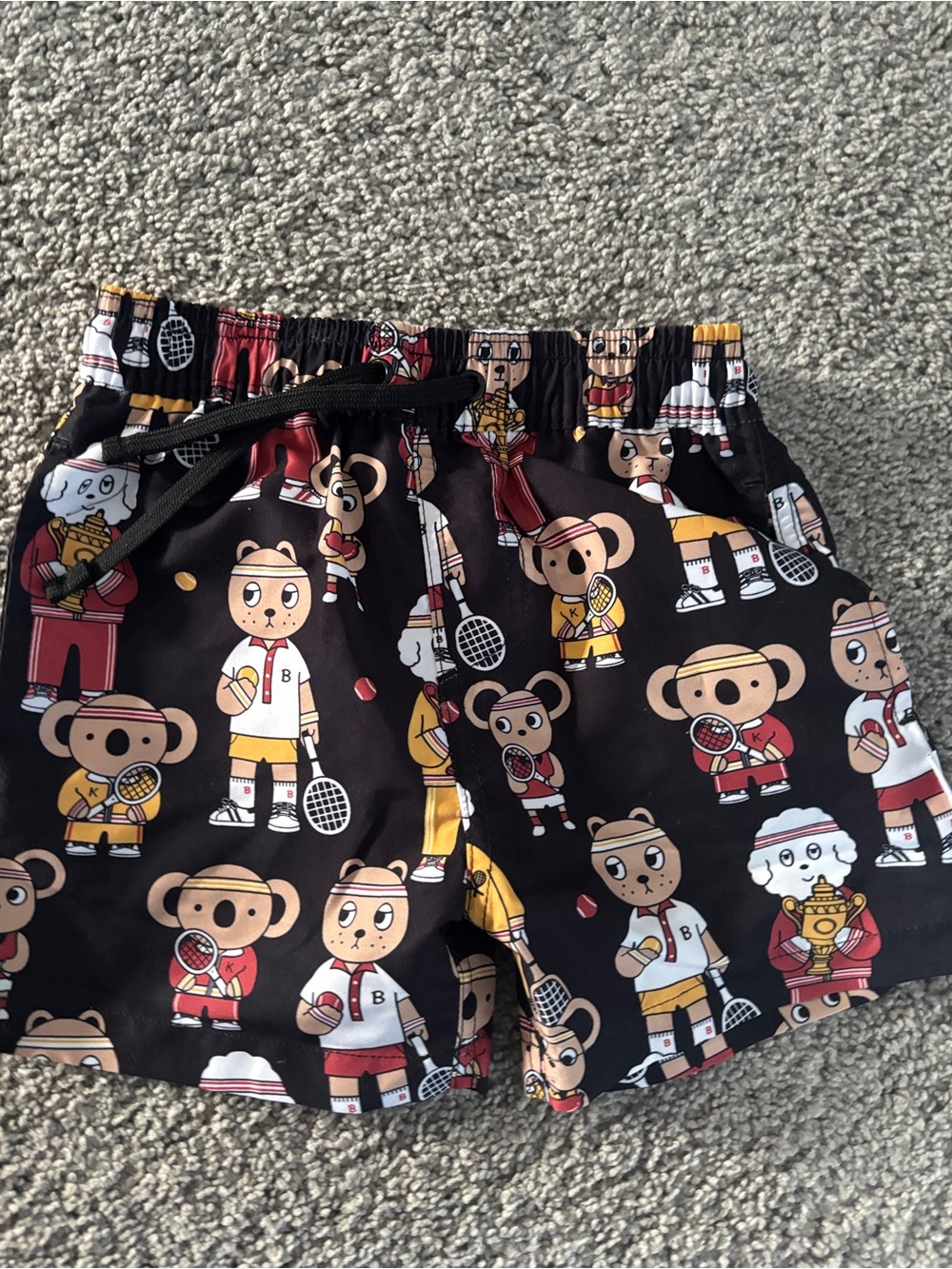 Huxbaby Black Bear Tennis Cartoon Swim Shorts with Red & Yellow Accents